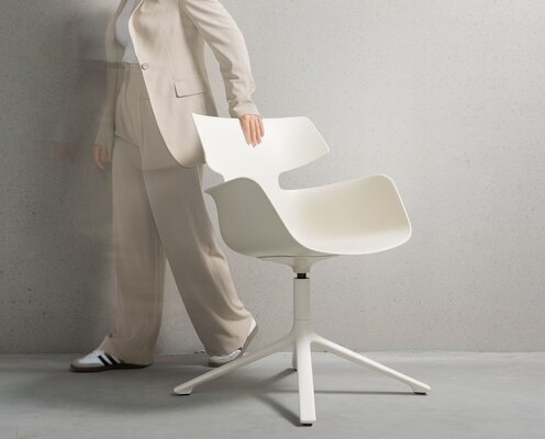 Sand-colored shell chair with four legs