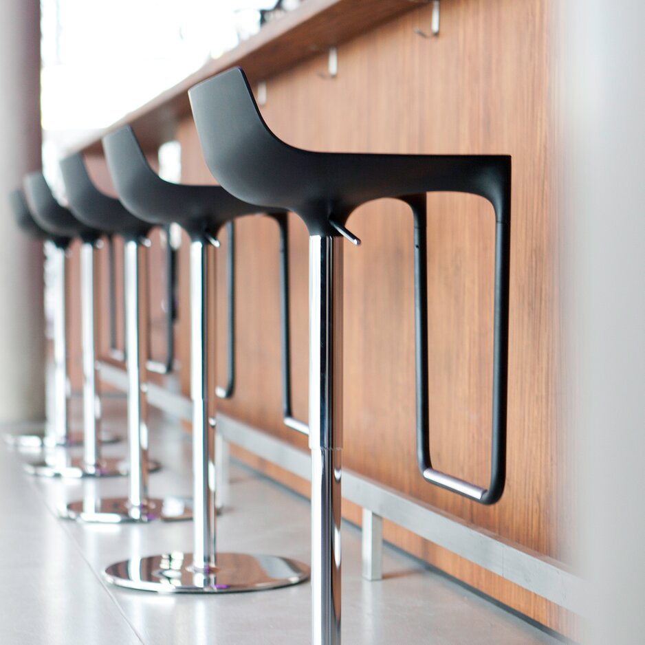 Black barstools at a counter.