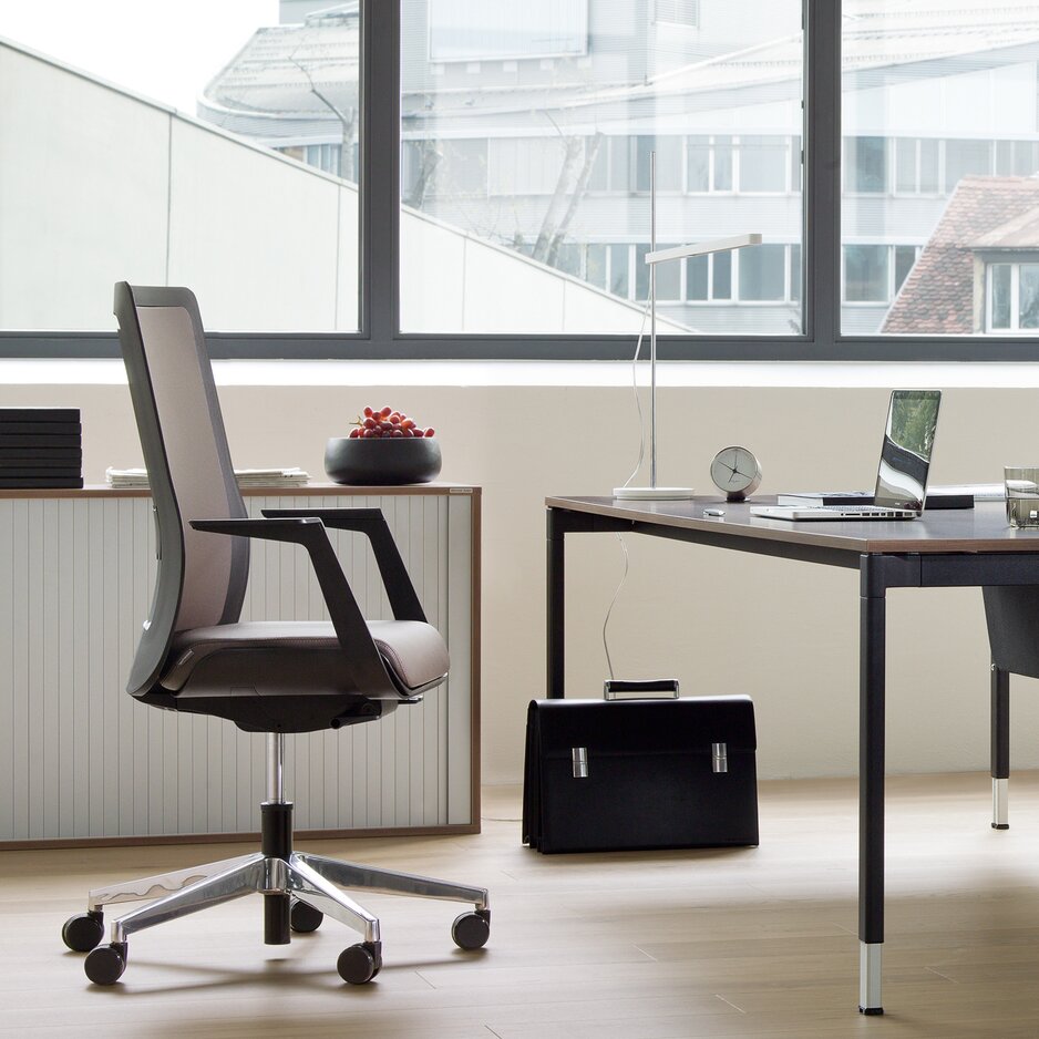 Black swivel chair at an office desk.