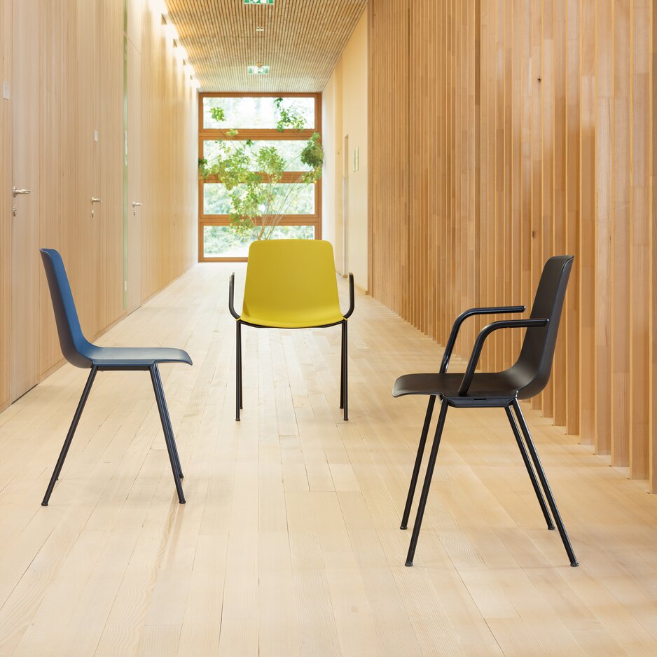 Three chairs in a wooden hallway.