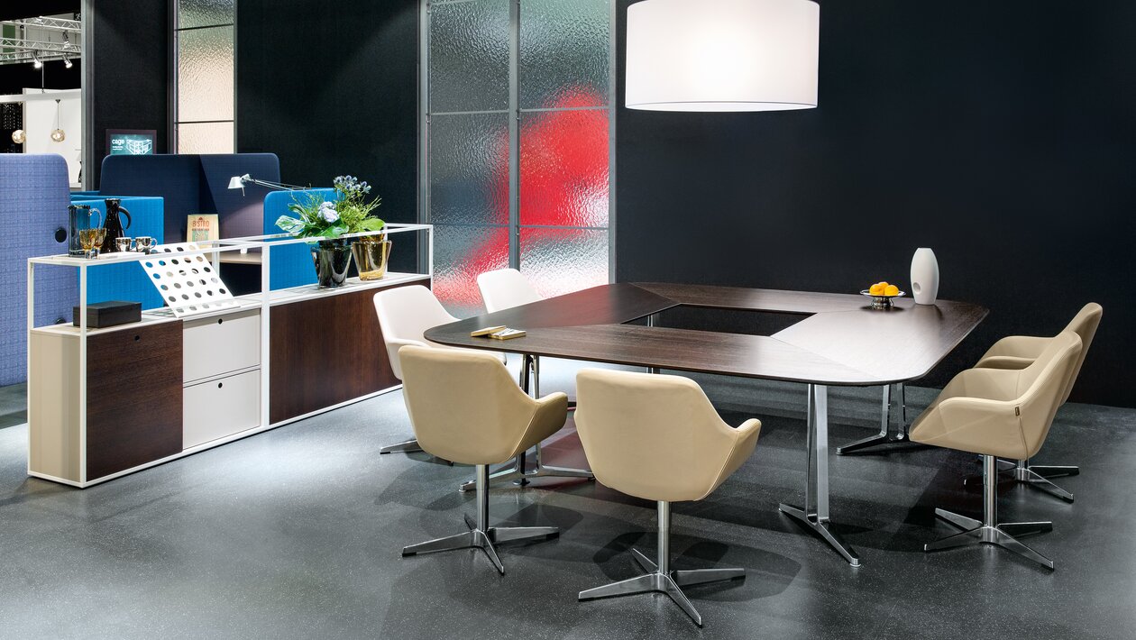 Conference table with white shell chairs.