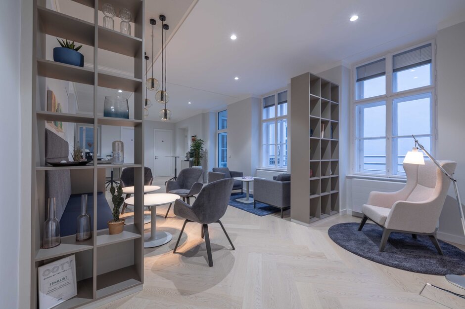 Lounge area with gray chairs and hanging lamps. | © Martin Zorn Photography