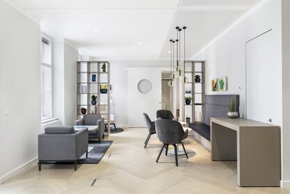 Lounge area with gray lounge seating and hanging lamps | © PicMyPlace