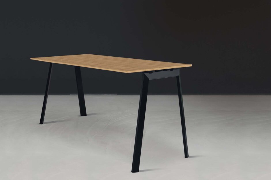 Folding table in front of a black wall.