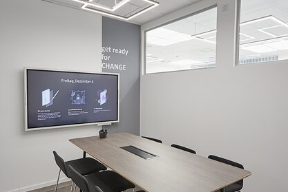 AHT Meeting room with black barstools and a high table.