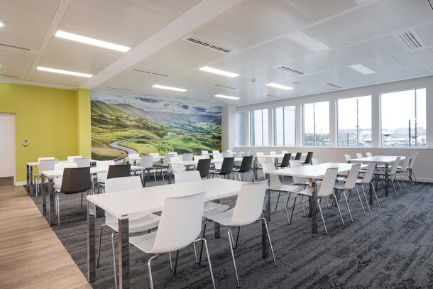 Canteen with white tables and white chairs. | © Ford Motor Company Limited