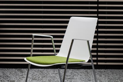 White stacking chair with green seat. | © Ford Motor Company Limited