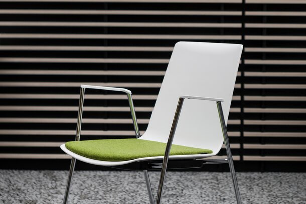 Ford | © Ford Motor Company Limited White stacking chair with green seat. | © Ford Motor Company Limited