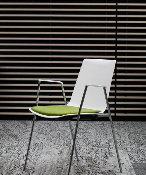White stacking chair with green seat. | © Ford Motor Company Limited