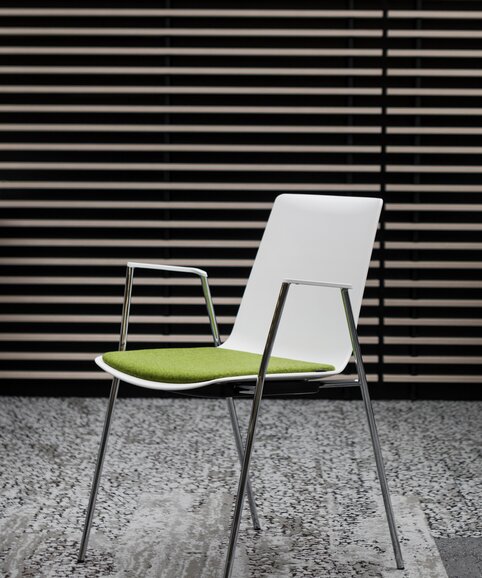 Ford | © Ford Motor Company Limited White stacking chair with green seat. | © Ford Motor Company Limited