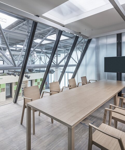 Meeting room with a wooden table and wooden chairs.