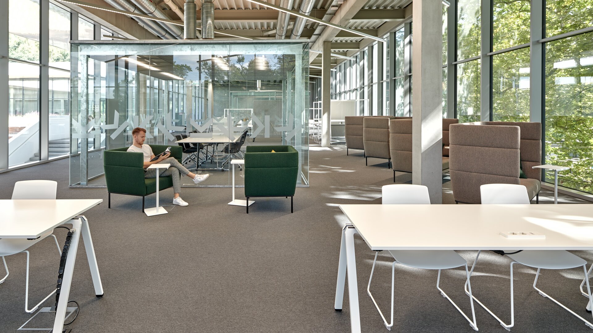 JKU Learning Center | © raumpixel.at Person is sitting on a green lounge seating. | © raumpixel.at