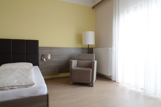 Bedroom with brown lounge seating.