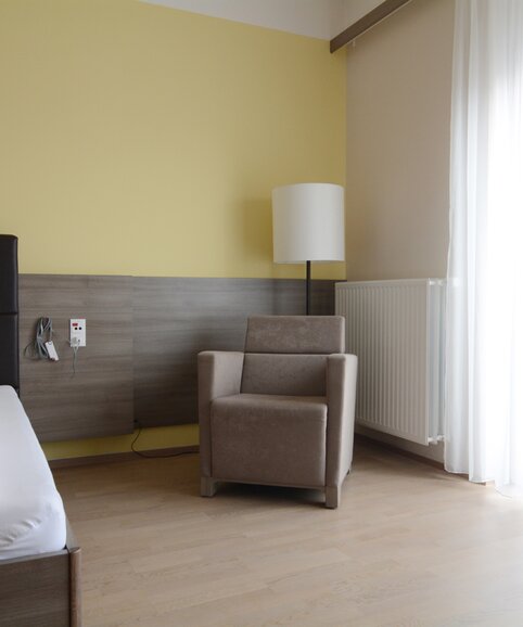 Bedroom with brown lounge seating.