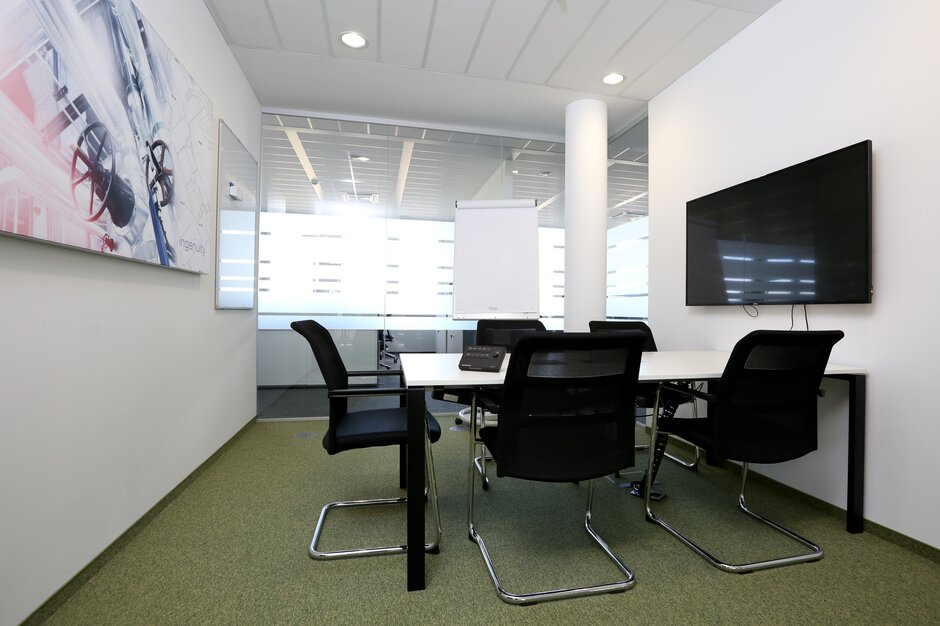 Meeting room with black cantilever chairs. 