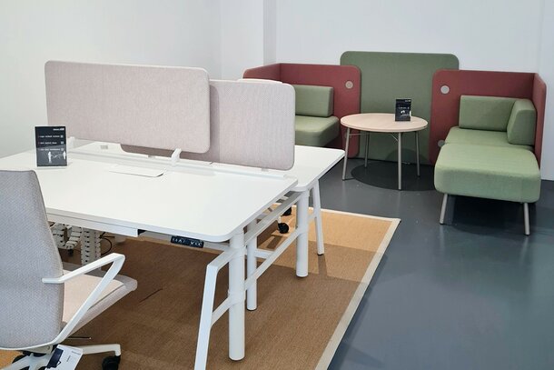 Clerkenwell Design Week White desk with rose swivel chair and lounge seating.