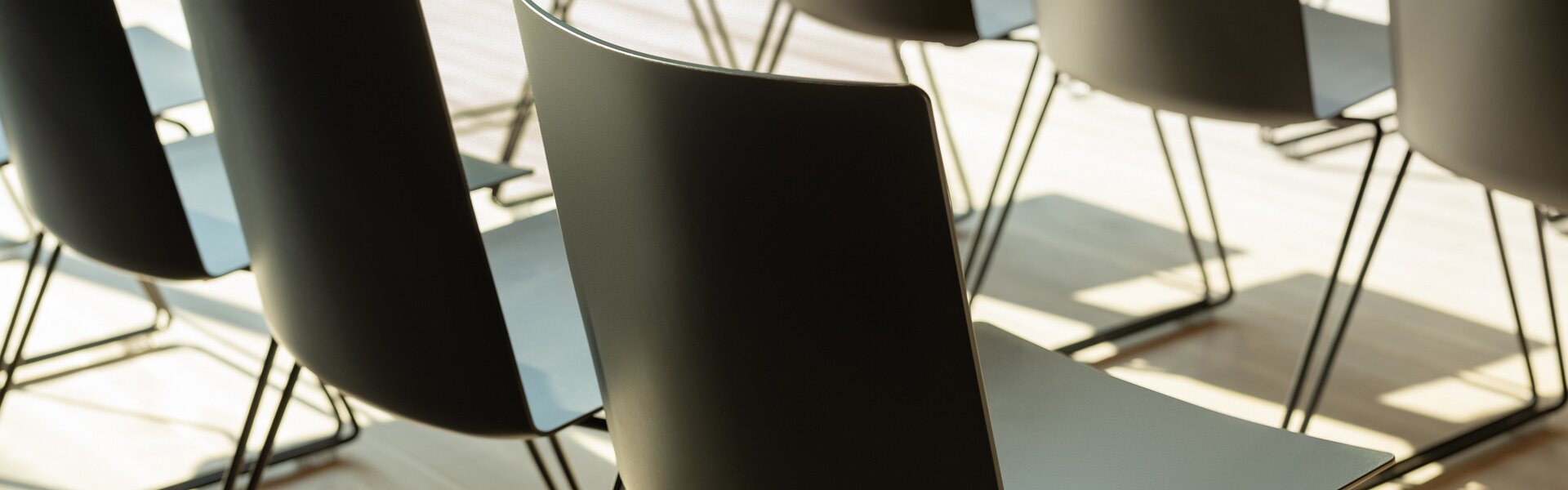 Detail shot of black rows of chairs.