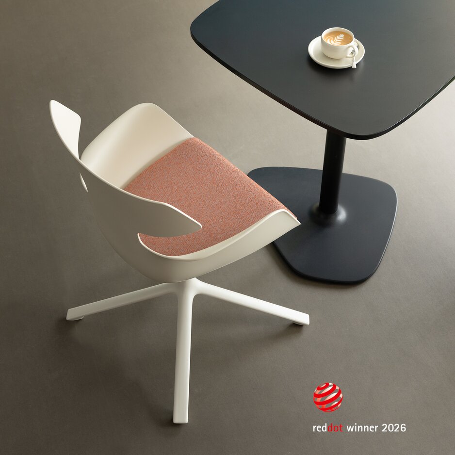White shell chair with red upholstery and four legs