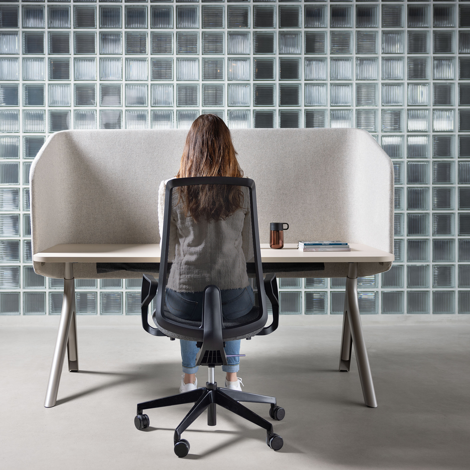 A person is sitting on a swivel Chair