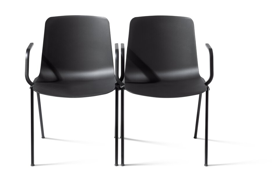 puc stacking chair Two black linked chairs.