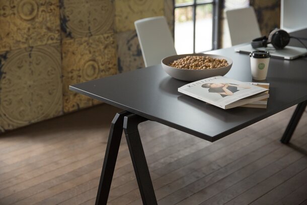 Black stacking table with a white chair.