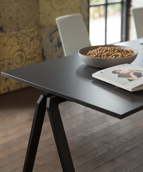 Black stacking table with a white chair.