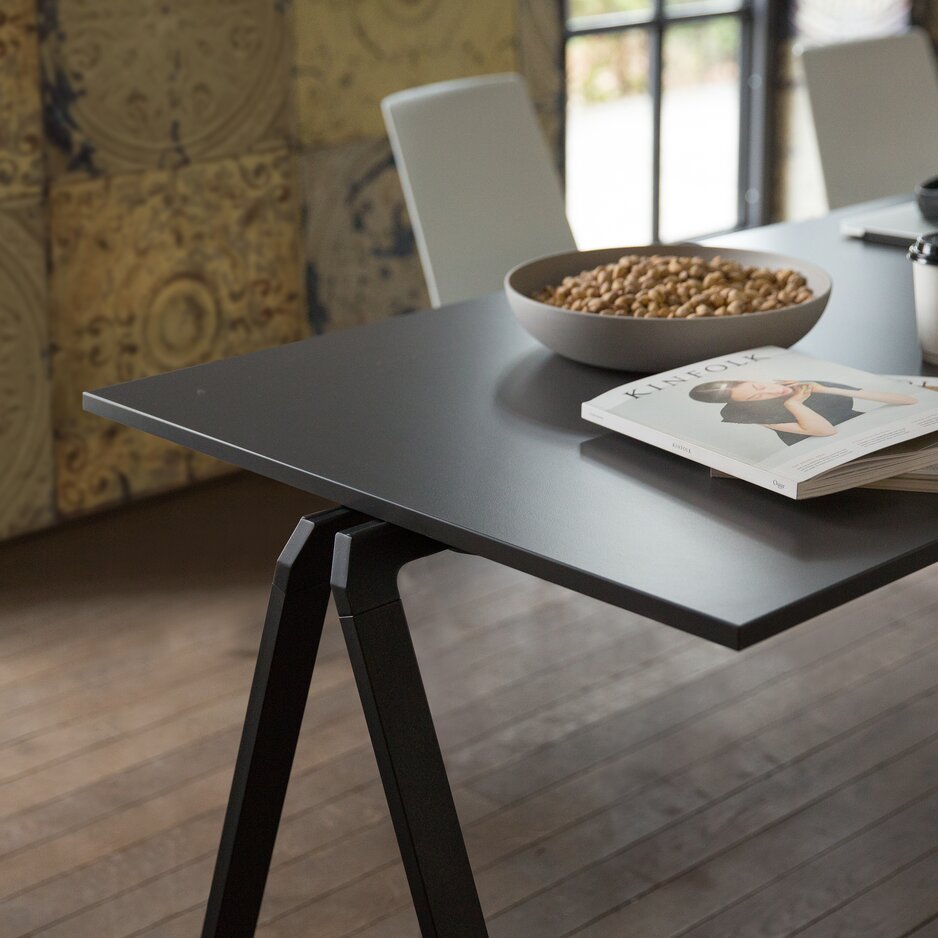 Black stacking table with a white chair.