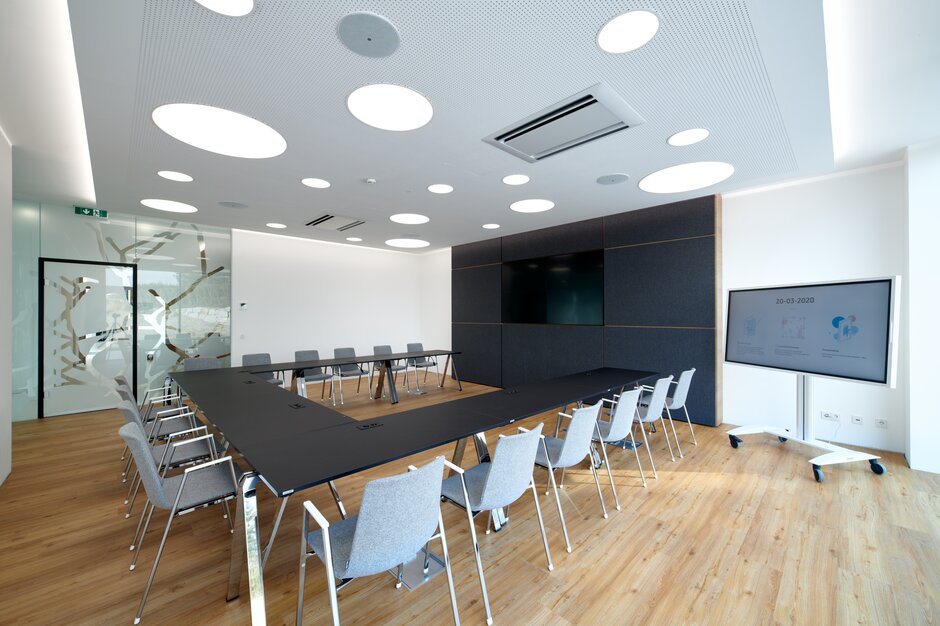 Black meeting table with gray chairs. 