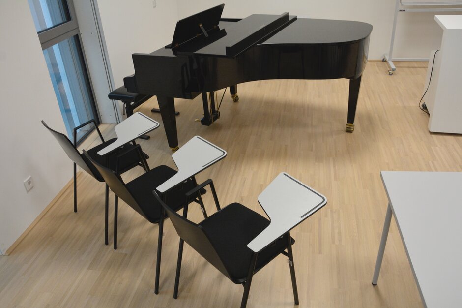 Raum mit einem Klavier und zwei schwarzen Stühlen. | © Roland Halbe Fotografie