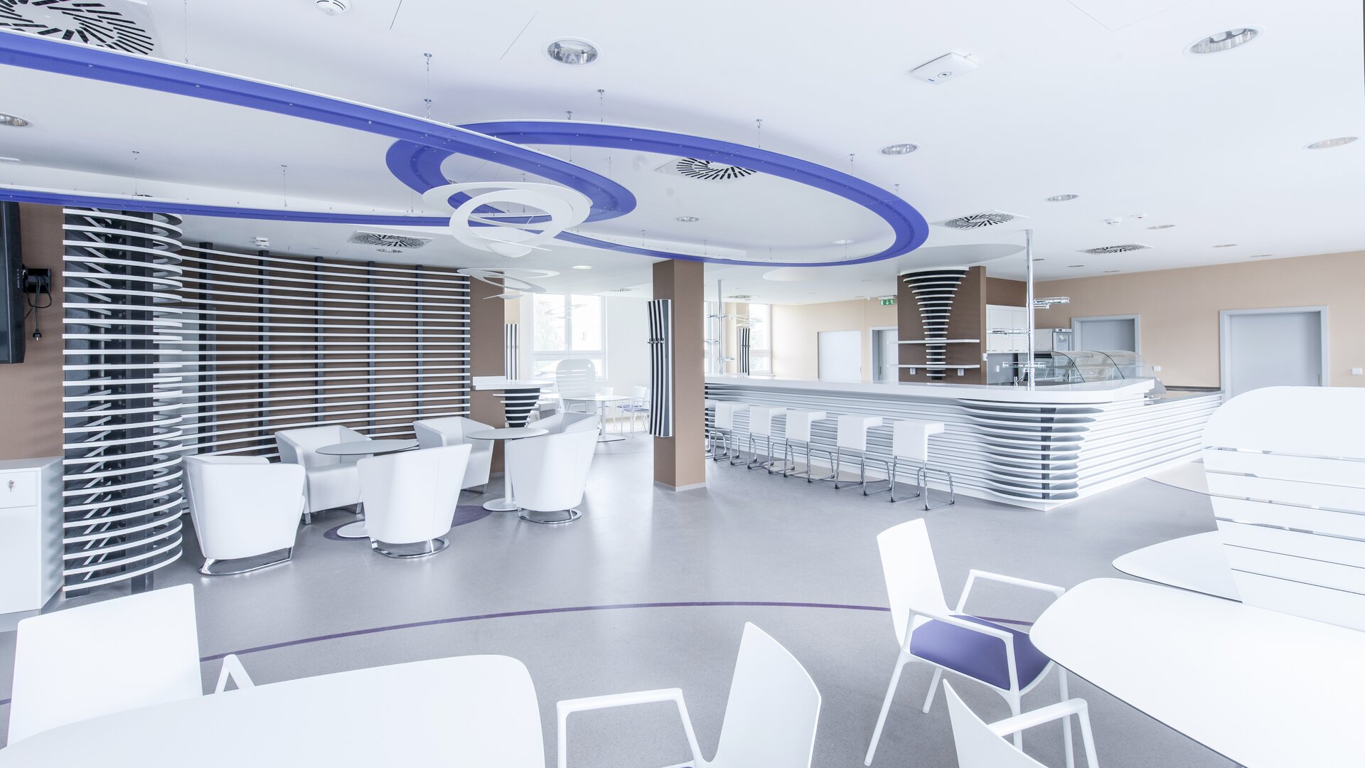 Cani Restaurant with white tables and chairs.