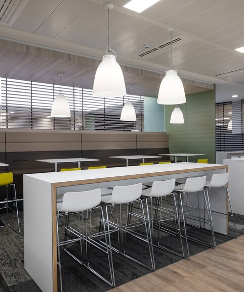 White high tables with white and yellow barstools. | © Ford Motor Company Limited