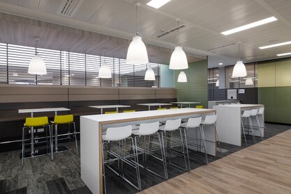 White high tables with white and yellow barstools. | © Ford Motor Company Limited