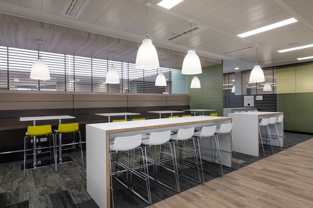 Ford | © Ford Motor Company Limited White high tables with white and yellow barstools. | © Ford Motor Company Limited