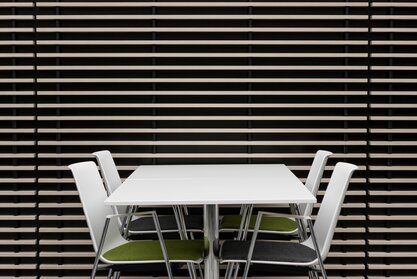 Ford | © Ford Motor Company Limited White table with colourful chairs. | © Ford Motor Company Limited