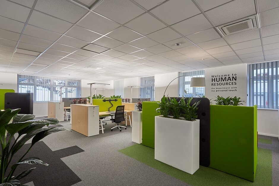 Office room with desks, swivel chairs and middle zones.